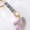 A golden circular diamond-encrusted pendant in the shape of a high heel Application Scenario